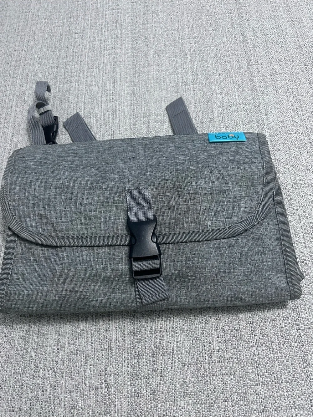 Grey Foldable Portable Changing Pad for Baby with Secure Buckle.